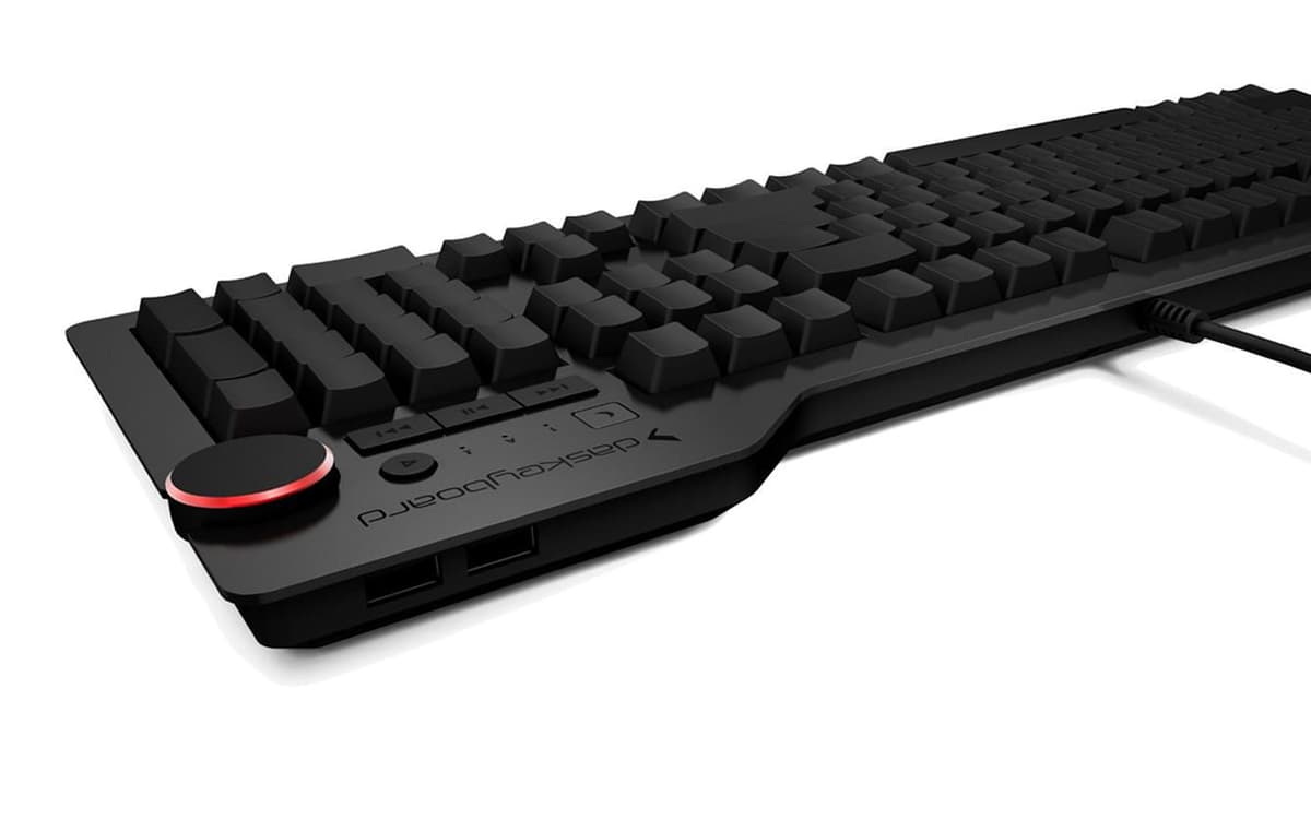 A Das Keyboard 4 Ultimate at an angle, every keycap blank, with the volume knob lit red