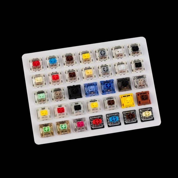 A switch tester board holding around thirty mechanical switches, each with a differently coloured stem
